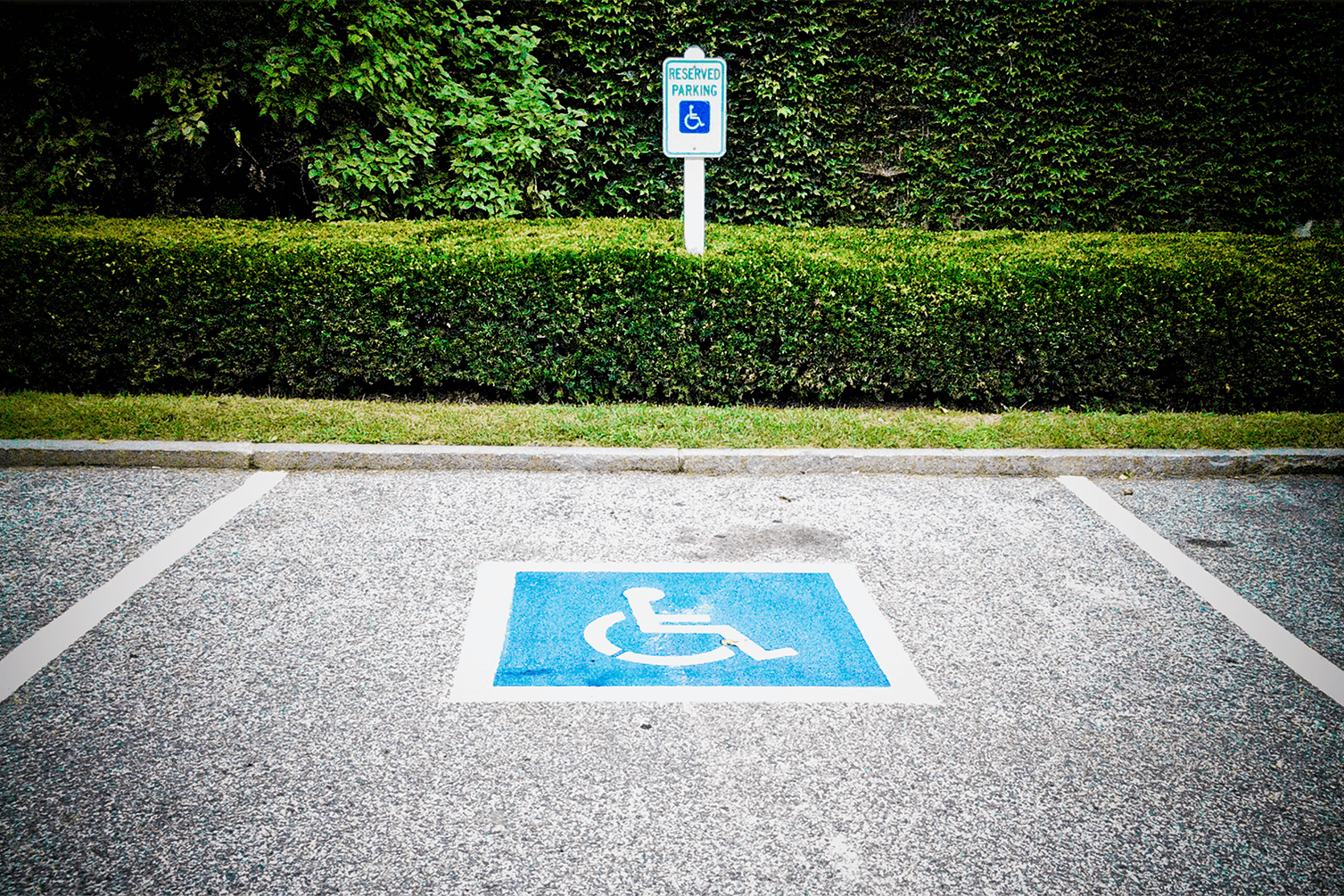Abbattimento delle barriere architettoniche - parcheggio per disabili e sullo sfondo giardino